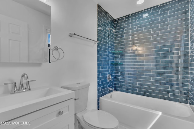 bathroom with toilet, bathing tub / shower combination, and vanity