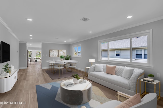 living area featuring crown molding, recessed lighting, and baseboards