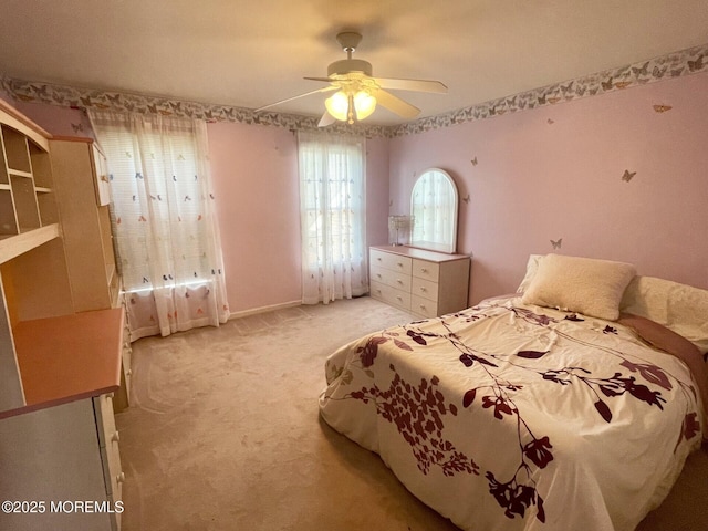 bedroom featuring baseboards, light carpet, and a ceiling fan