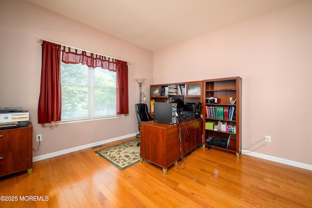 office with light wood-style floors, baseboards, and visible vents