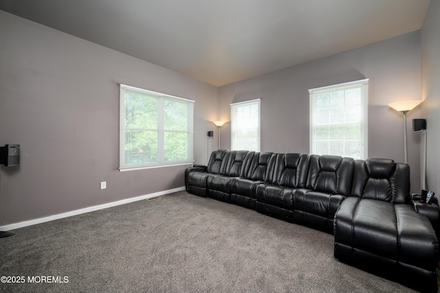 carpeted living area with baseboards