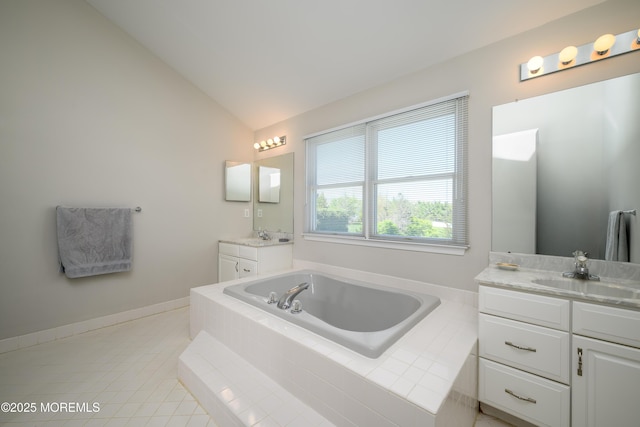 bathroom featuring tile patterned flooring, a bath, two vanities, a sink, and vaulted ceiling
