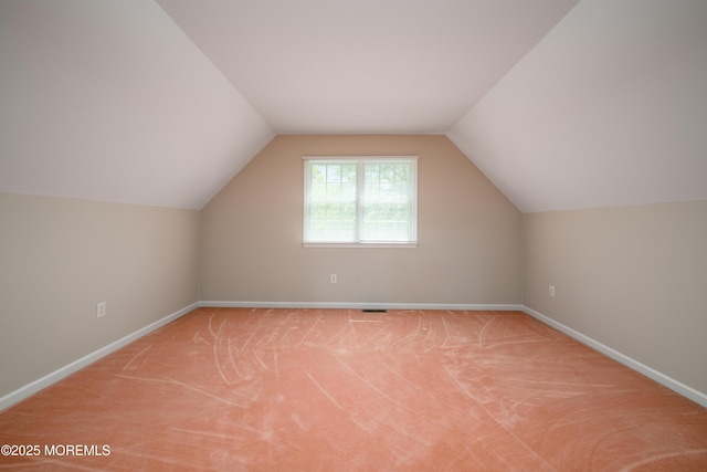 bonus room with baseboards, carpet, and lofted ceiling