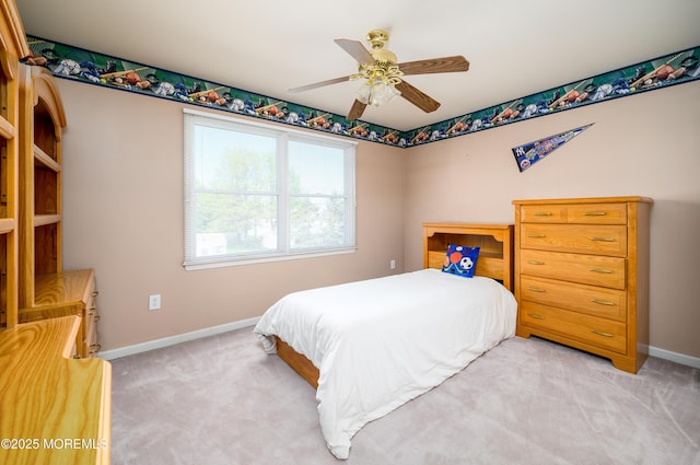 bedroom with a ceiling fan, baseboards, and light colored carpet