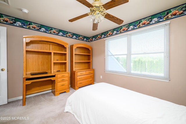 bedroom with a ceiling fan and light carpet