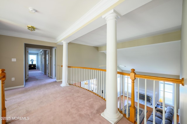 hallway with crown molding, carpet flooring, decorative columns, and a wealth of natural light