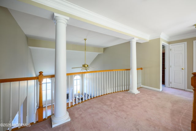 hallway with ornate columns, lofted ceiling, ornamental molding, and carpet