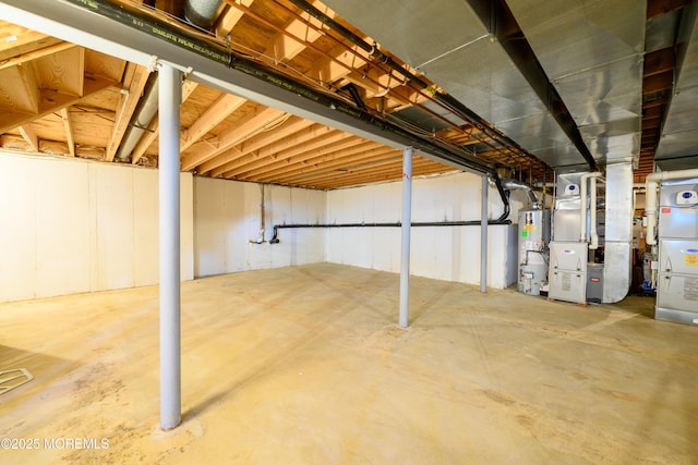 unfinished below grade area featuring heating unit and water heater