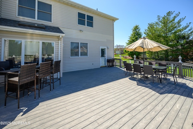 wooden deck with outdoor dining area