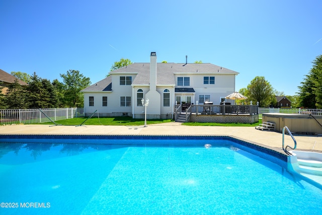 view of swimming pool featuring fence, a fenced in pool, a hot tub, and a deck