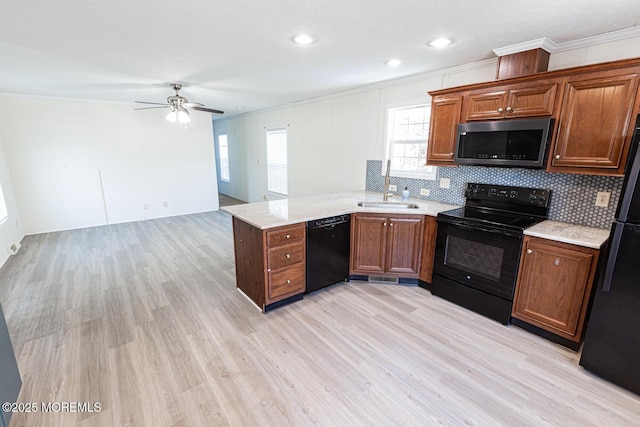 89 Woodchuck Pkwy, Whiting, NJ 08759 - kitchen with crown molding, a sink, light wood-style flooring, and black appliances