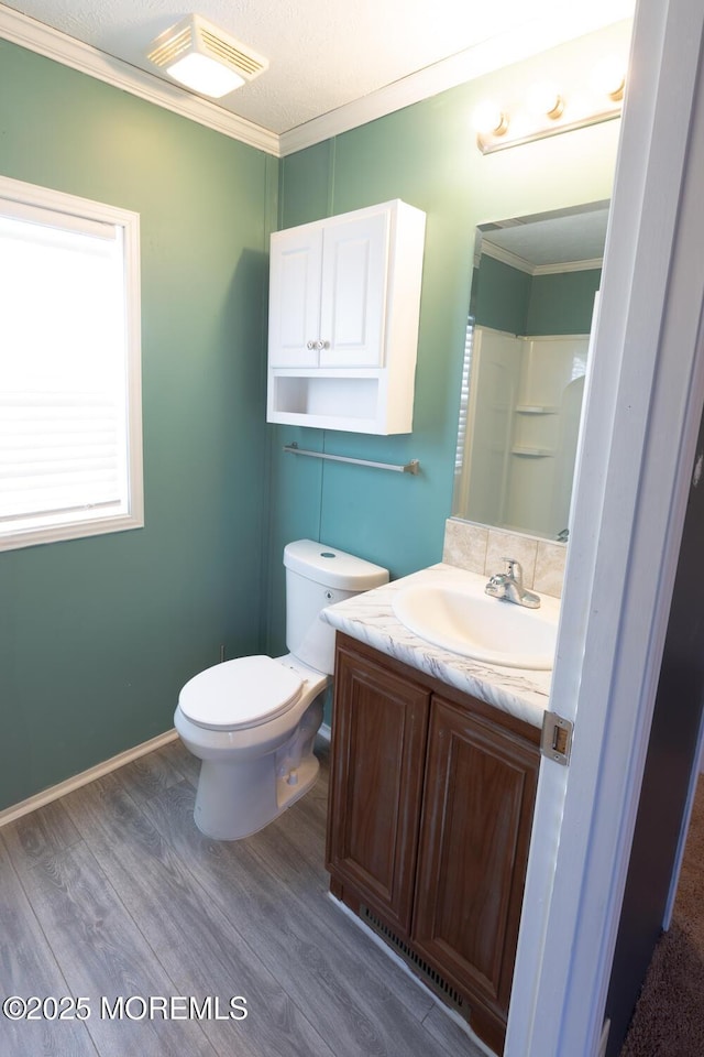 89 Woodchuck Pkwy, Whiting, NJ 08759 - bathroom featuring visible vents, wood finished floors, vanity, toilet, and ornamental molding