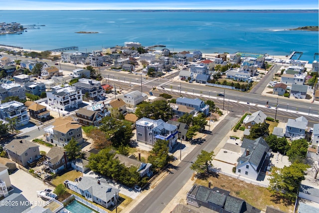 birds eye view of property featuring a water view and a residential view