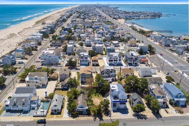 aerial view with a water view, a view of the beach, and a residential view