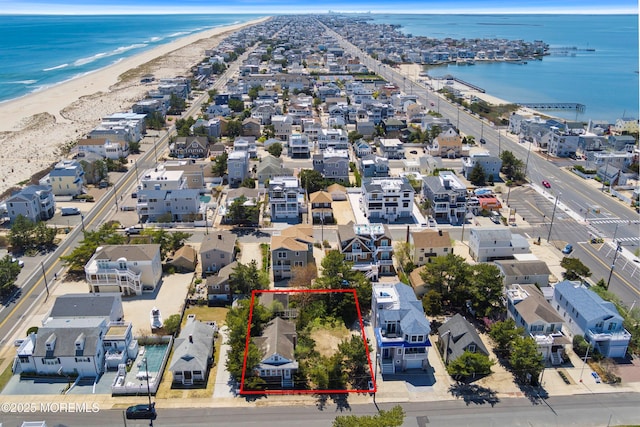 bird's eye view with a water view, a residential view, and a view of the beach
