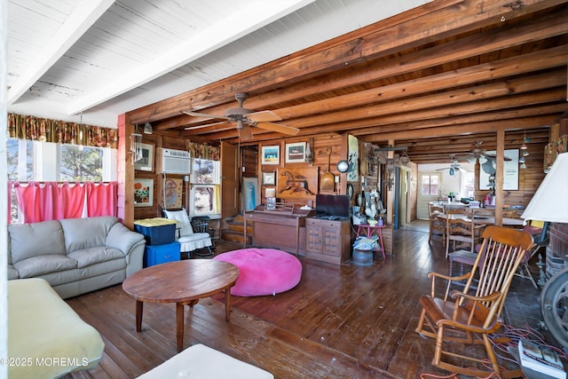 living room with beamed ceiling, wood-type flooring, and a ceiling fan
