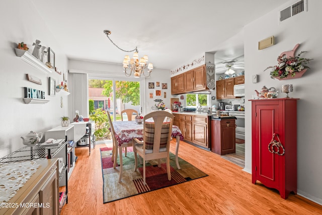 435B New Castle Ct, Manchester, NJ 08759 - dining room with a wealth of natural light, ceiling fan with notable chandelier, light wood-type flooring, and visible vents