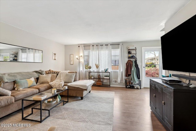 living room featuring light wood-type flooring and visible vents