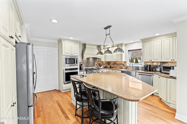 kitchen with decorative backsplash, a kitchen island, appliances with stainless steel finishes, a sink, and custom exhaust hood