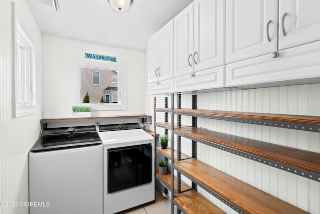 clothes washing area with cabinet space and washing machine and clothes dryer