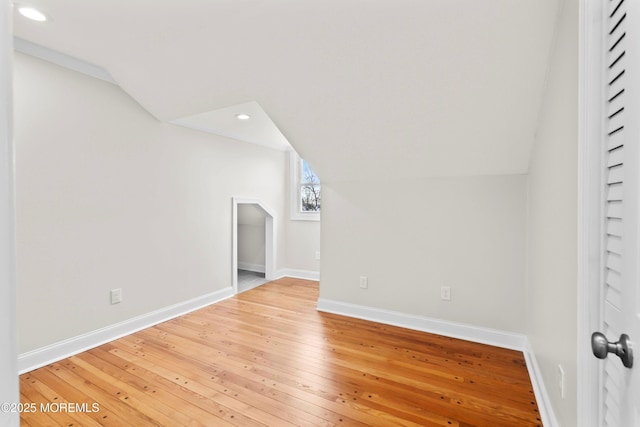 bonus room with baseboards, recessed lighting, light wood-style flooring, and lofted ceiling