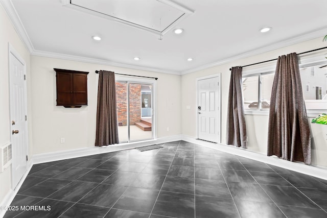 spare room featuring crown molding, attic access, baseboards, and recessed lighting