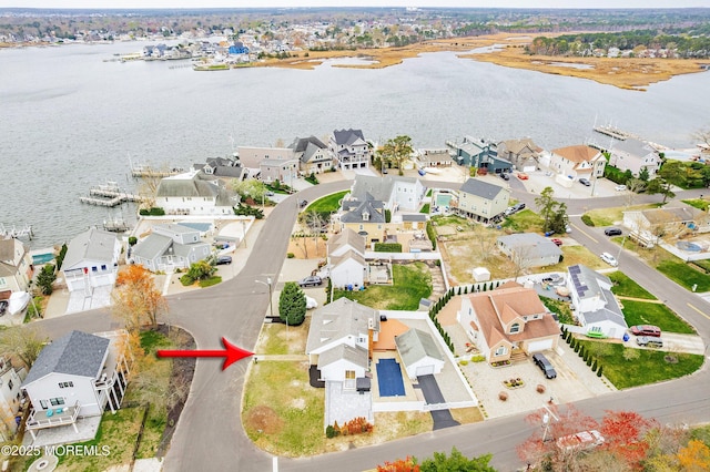bird's eye view with a residential view and a water view