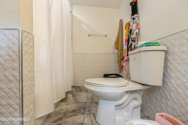 1603 Berkeley Ave, Beachwood, NJ 08722 - bathroom with toilet, tile walls, a wainscoted wall, and a shower with shower curtain