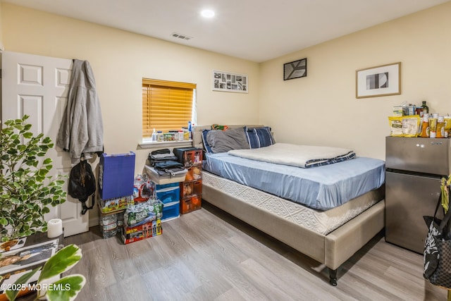 1603 Berkeley Ave, Beachwood, NJ 08722 - bedroom featuring freestanding refrigerator, wood finished floors, and recessed lighting
