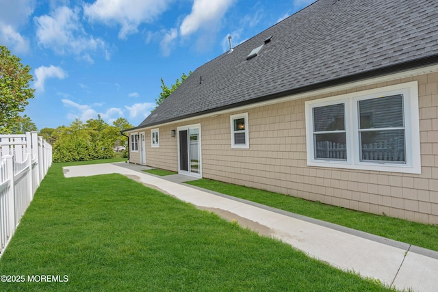 back of property featuring roof with shingles and a patio area