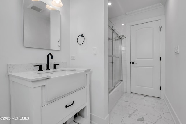 bathroom featuring marble look tiles, baseboards, vanity, enclosed tub / shower combo, and ornamental molding