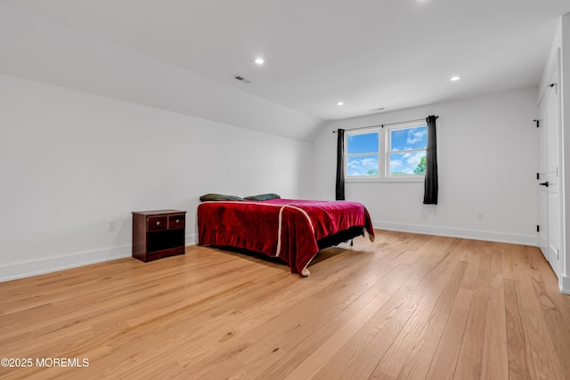 bedroom featuring light wood-type flooring, baseboards, lofted ceiling, and recessed lighting