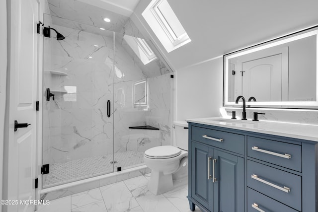 bathroom featuring a skylight, toilet, marble finish flooring, a marble finish shower, and vanity