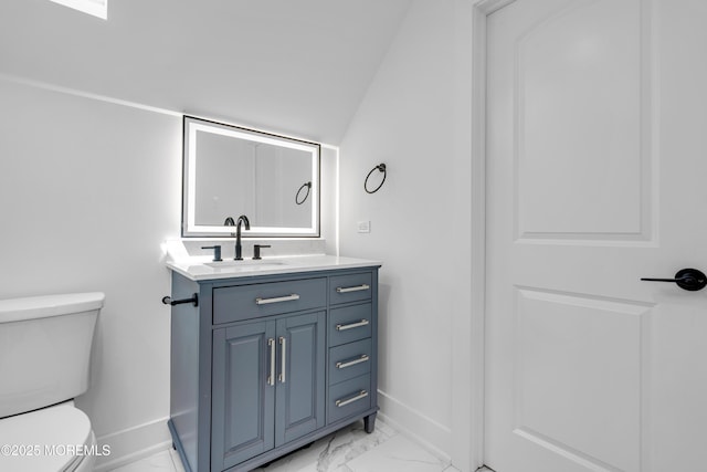 bathroom with baseboards, marble finish flooring, toilet, and vanity