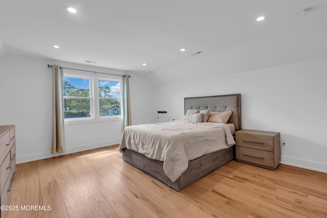 bedroom with lofted ceiling, light wood-style floors, baseboards, and recessed lighting