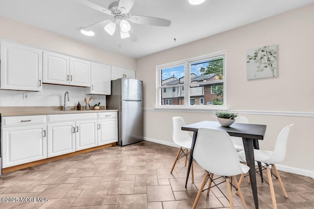 38 Adriana Ct, Brick, NJ 08724 - kitchen featuring freestanding refrigerator, a sink, baseboards, white cabinets, and a ceiling fan