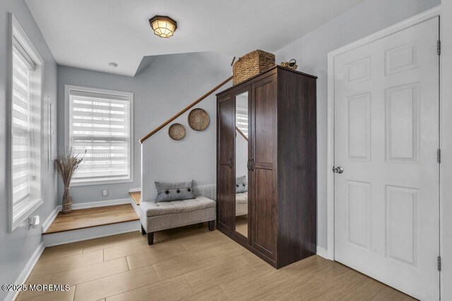 living area featuring baseboards and light wood-style floors
