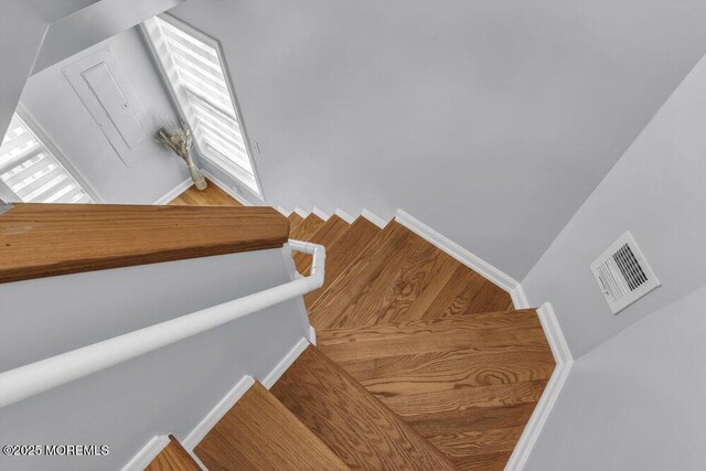 stairs with visible vents and baseboards