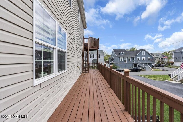 wooden terrace with a residential view
