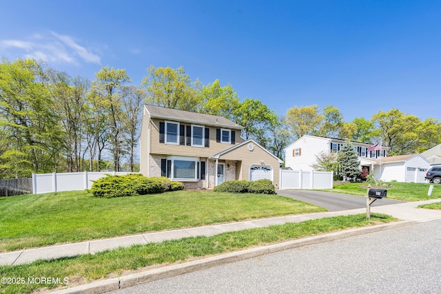 view of front of home featuring fence, brick siding, driveway, a garage, and a front lawn