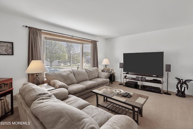 carpeted living area featuring baseboards