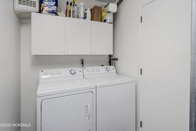 laundry room featuring cabinet space and washer and clothes dryer