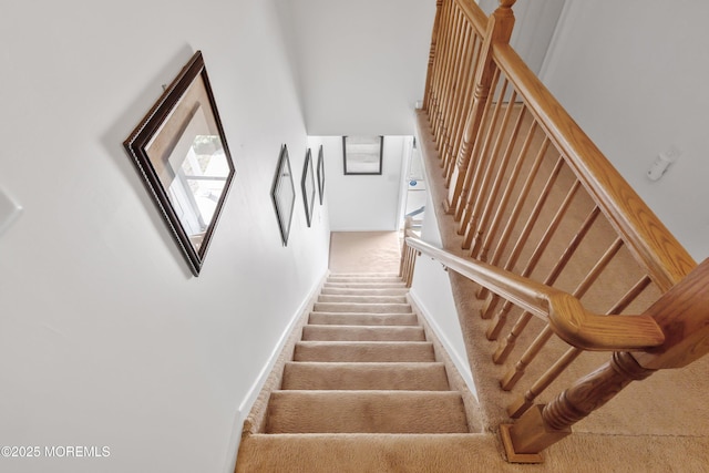 stairway with carpet floors and baseboards