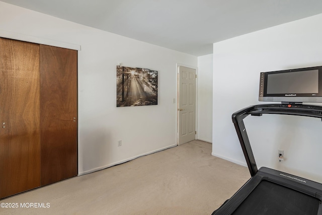 workout area with carpet flooring and baseboards