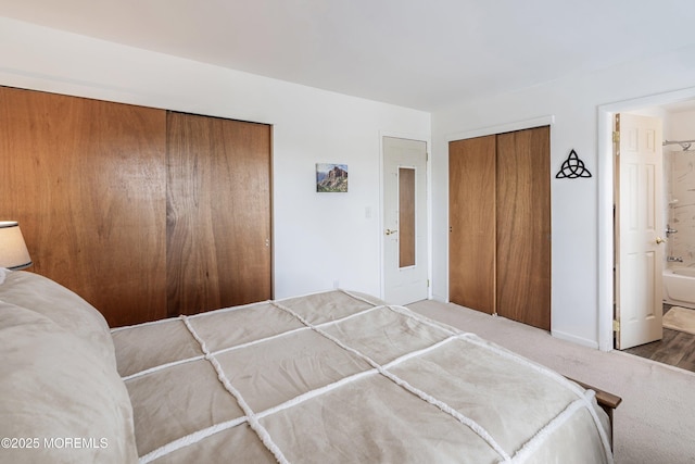 unfurnished bedroom featuring ensuite bathroom and baseboards