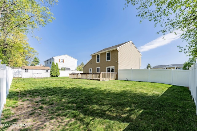 view of yard with a wooden deck and a fenced backyard