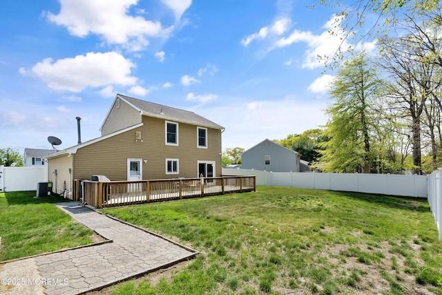 rear view of property featuring a fenced backyard, a wooden deck, a yard, and central AC unit