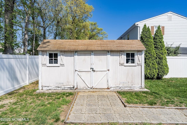 view of shed with fence private yard