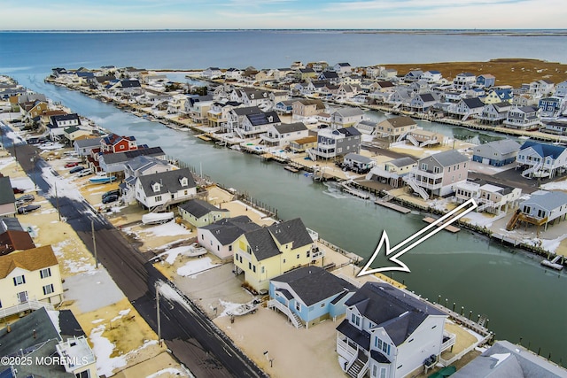 drone / aerial view featuring a water view and a residential view