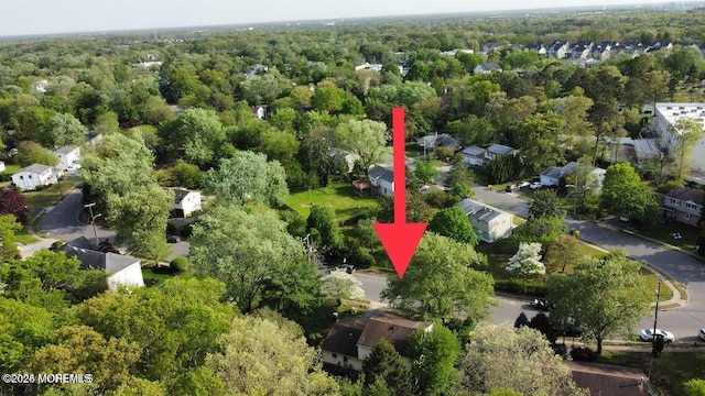 drone / aerial view with a forest view and a residential view
